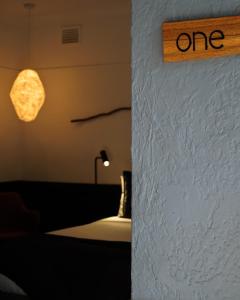 a dimly lit room with a lamp on the wall at Bowral Boutique Motel in Bowral