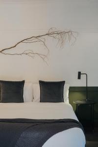 an unmade bed with a plant on top of it at Bowral Boutique Motel in Bowral