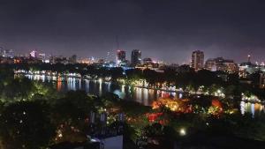 a city lit up at night with a river at Hanoi HM Boutique Hotel in Hanoi