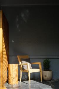 a chair sitting in front of a wooden table at Bowral Boutique Motel in Bowral