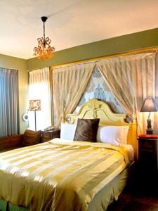 a bedroom with a bed and a chandelier at Raid Garden Boutique Hotel in Magong