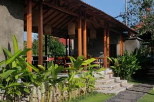 a porch of a house with a bunch of plants at Bingin Lodge Uluwatu in Uluwatu