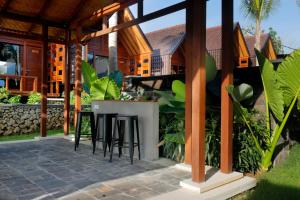 a patio with a bar in a house at Bingin Lodge Uluwatu in Uluwatu