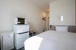En eller flere senge i et værelse på HOTEL R9 The Yard Futtsu