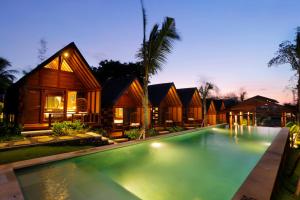 a villa with a swimming pool at night at Bingin Lodge Uluwatu in Uluwatu +37 photos