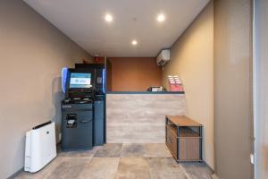 a small kitchen with a refrigerator and a counter at HOTEL R9 The Yard Futtsu in Futtsu