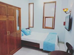 Khách sạn Nghinh Phong Beach Tuy Hòa في توي هوا: غرفة نوم بسرير وخزانة خشبية