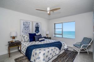 a bedroom with a bed and a window with the ocean at Pacific Plaza Apartments in Gold Coast