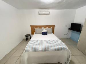 a bedroom with a bed and a television in it at Tropical Home in excellent location just 10 min from Nuevo Vallarta Beach in Mezcales