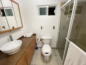 a bathroom with a toilet and a sink and a shower at Tropical Home in excellent location just 10 min from Nuevo Vallarta Beach in Mezcales