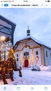 a statue of a cow in front of a church at Chalet LA TOUPINE centre St Gervais in Saint-Gervais-les-Bains