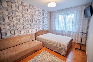 a living room with a couch and a window at Holiday and Travel Apartment in Brest