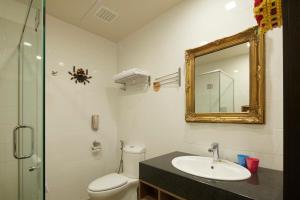 un bagno con un water, un lavandino e uno specchio di Legoland Malaysia Hotel a Nusajaya