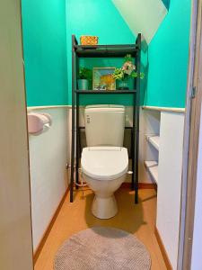 a bathroom with a toilet with a shelf above it at Lucy's House横浜中華街 House5 in Yokohama