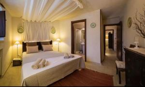 a bedroom with a large bed with towels on it at Spacious Villa with Private Pool in Castellana Grotte in Alberobello