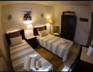 a hotel room with two beds and two lamps at Spacious Villa with Private Pool in Castellana Grotte in Alberobello +10 photos