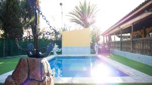 a swimming pool in a yard next to a house at Elegant Villa in Archena + Private Pool in Archena