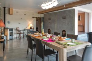 a dining room with a wooden table and chairs at Maison de 5 chambres avec piscine privee terrasse amenagee et wifi a La Digne d'Aval in La Digne-dʼAval