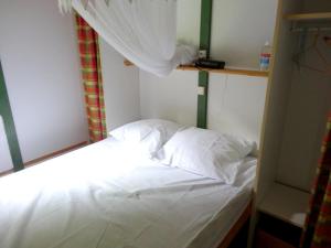 เตียงในห้องที่ Bungalow de 2 chambres avec jardin a Pointe Noire a 1 km de la plage