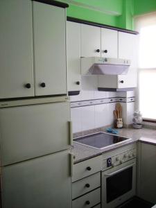 a kitchen with a white refrigerator and a sink at 3 bedrooms appartement with city view and wifi at Santa Cruz de la Palma in Santa Cruz de la Palma