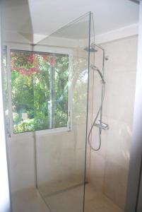 a glass shower in a bathroom with a window at Heavenly Villa in Gustavia with Private Pool in Gustavia