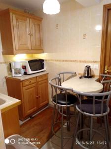 a kitchen with a table and chairs and a microwave at Appartement d'une chambre avec jardin clos et wifi a Alfortville in Alfortville