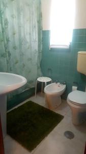 a bathroom with a sink and a toilet and a shower at Charming Apartment in Quarteira - 50 sqm - Balcony with View in Quarteira