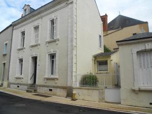 a white building on the side of a street at Maison de 3 chambres avec jardin clos et wifi a Airvault in Airvault