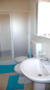 a bathroom with a sink and a toilet and a shower at 4 bedrooms house with furnished terrace and wifi at Marinella di Selinunte 1 km away from the beach in Marinella di Selinunte