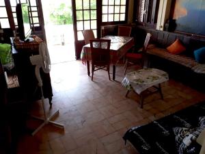a living room with a table and chairs in a room at Maison de 2 chambres a Sainte Anne a 100 m de la plage avec vue sur la mer jardin clos et wifi in Sainte-Anne