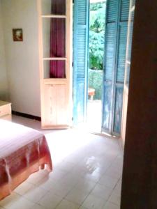 a bedroom with a bed and a door open at Appartement de 2 chambres avec jardin clos et wifi a Bocognano in Bocognano