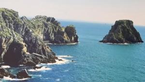 a view of the ocean with rocks in the water at Maison de charme à Primelin avec jardin et parking privé in Primelin