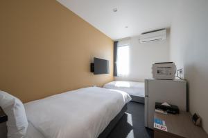 Postel nebo postele na pokoji v ubytování HOTEL R9 The Yard Utsunomiya chuo