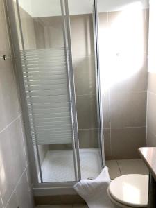 a shower with a glass door in a bathroom at Maison de 2 chambres avec piscine partagee terrasse amenagee et wifi a Sainte Rose in Sainte-Rose