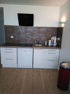 a kitchen with white cabinets and a sink at Appartement lumineux à Saint-Cyprien 45 m² vue mer in Saint-Cyprien