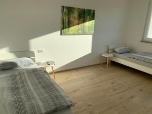 a bedroom with two beds and a painting on the wall at Haus Steingrubenweg in Mutlangen
