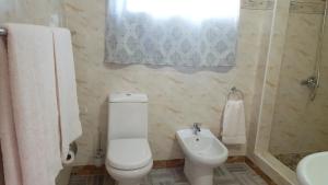 a bathroom with a toilet and a sink at One bedroom appartement with sea view enclosed garden and wifi at Baie Sainte Anne 5 km away from the beach in Baie Sainte Anne
