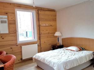 a bedroom with a white bed and a window at Appartement de 3 chambres avec jardin clos et wifi a Mont Saxonnex in Mont-Saxonnex