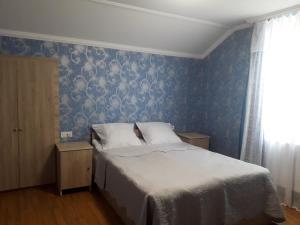 Rúm í herbergi á Akaki's Guesthouse