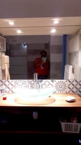a person taking a picture of a bathroom sink at Appartement d'une chambre a Sainte Anne a 500 m de la plage avec piscine privee jardin clos et wifi in Sainte-Anne