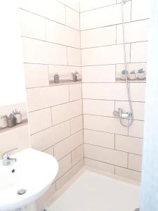 a white bathroom with a shower and a sink at Studio avec vue sur la ville balcon et wifi a Baie Mahault in Baie-Mahault