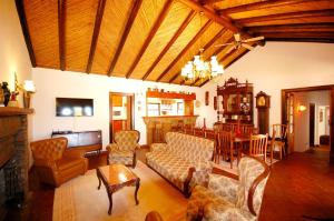 a living room with a couch and a table at Rustic Villa Tavira with Mountain Views and Pool in Tavira