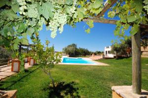 a yard with a swimming pool and a house at Rustic Villa Tavira with Mountain Views and Pool in Tavira