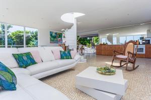 sala de estar con sofá blanco y mesa en Villa de 2 chambres avec vue sur la mer piscine privee et jardin clos a Sainte Rose, en Sainte-Rose