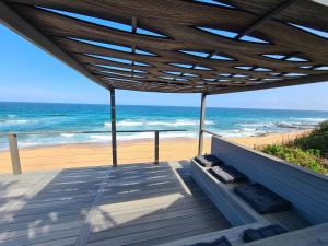 a deck with a view of the beach at Oceans Paradise in Ballito