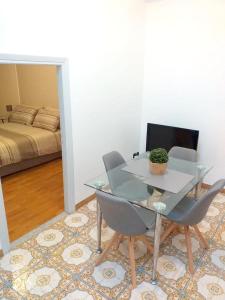 a dining room with a glass table and chairs at One bedroom appartement at Sanremo 40 m away from the beach with sea view furnished terrace and wifi in Sanremo