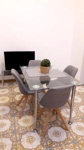 a dining table with two chairs and a laptop on a rug at One bedroom appartement at Sanremo 40 m away from the beach with sea view furnished terrace and wifi in Sanremo