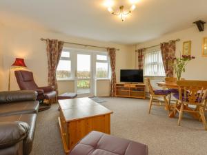 a living room with a couch and a table at Whimple Cottage in Exeter