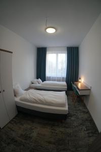 A bed or beds in a room at Stary Koszalin Hostel & Hotel Services