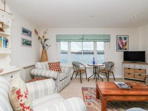 a living room with a couch and a table at Pier Cottage in Saint Mawes